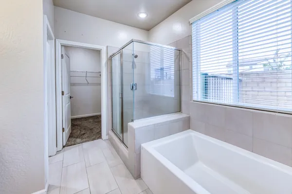 a bathroom with a bathtub and a shower