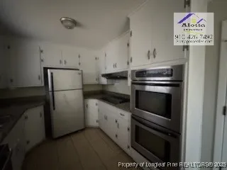 a kitchen with a refrigerator and a sink