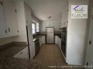 a view of empty room with window and ceiling fan
