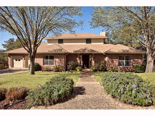 a front view of a building with a garden