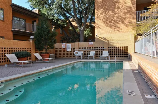 a view of house with swimming pool outdoor seating