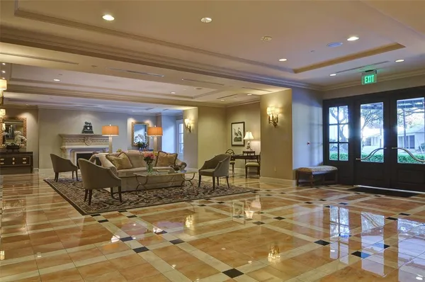 a living room with furniture a large window with table and chairs