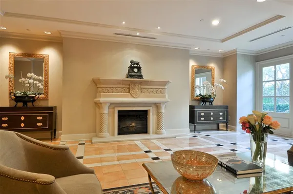 a living room with furniture a fireplace and a flat screen tv