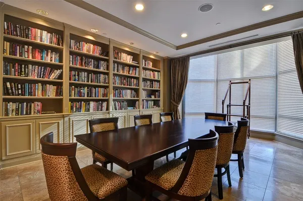 a view of a dining room with furniture and a book shelf