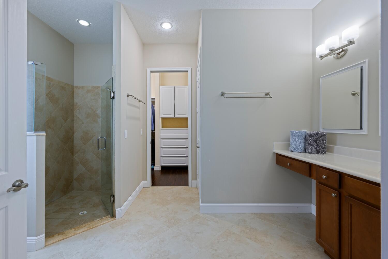 8024 Southwest Marin Drive Stuart, FL 34997 - Photo 13 of 26 a bathroom with a shower sink and mirror