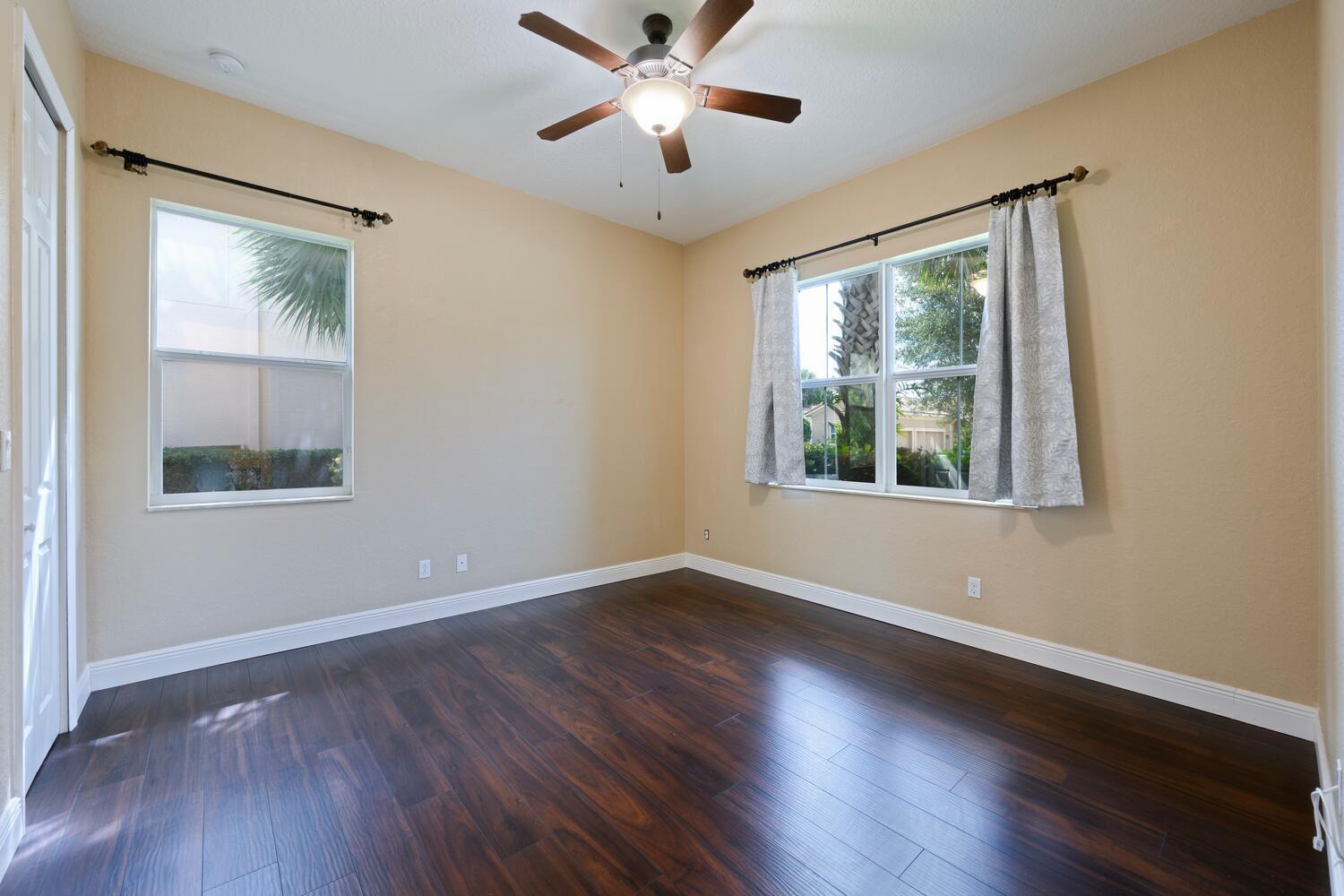 8024 Southwest Marin Drive Stuart, FL 34997 - Photo 15 of 26 a view of an empty room with wooden floor and a window