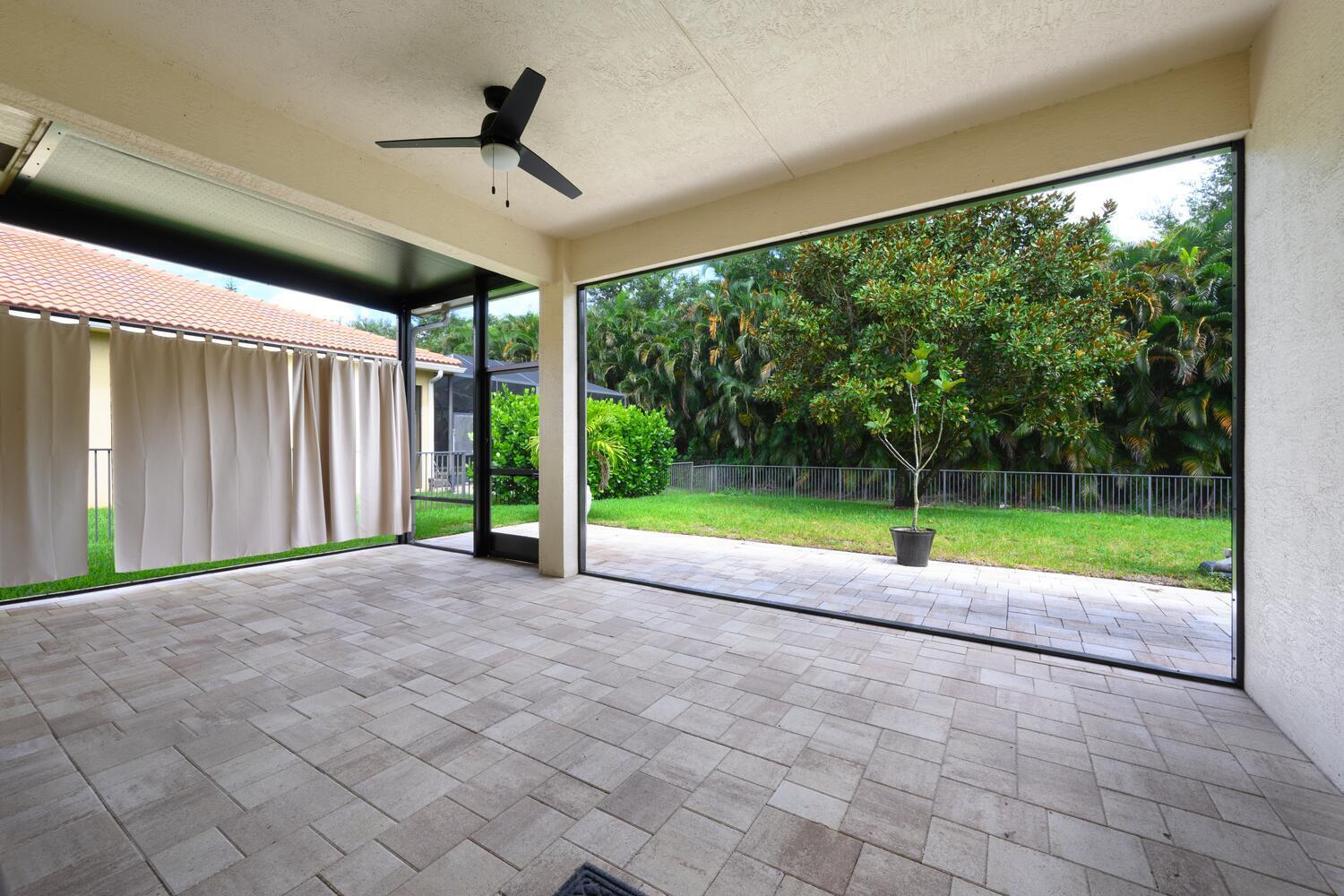 8024 Southwest Marin Drive Stuart, FL 34997 - Photo 22 of 26 a view of a room with porch and a yard