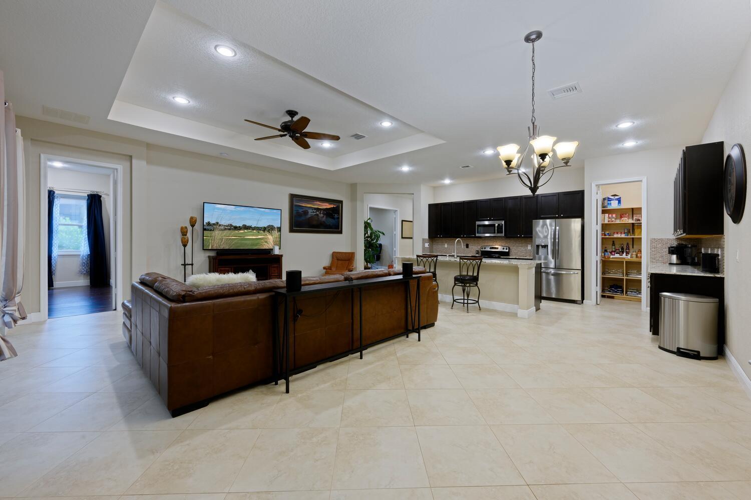 8024 Southwest Marin Drive Stuart, FL 34997 - Photo 7 of 26 a living room with furniture and a flat screen tv