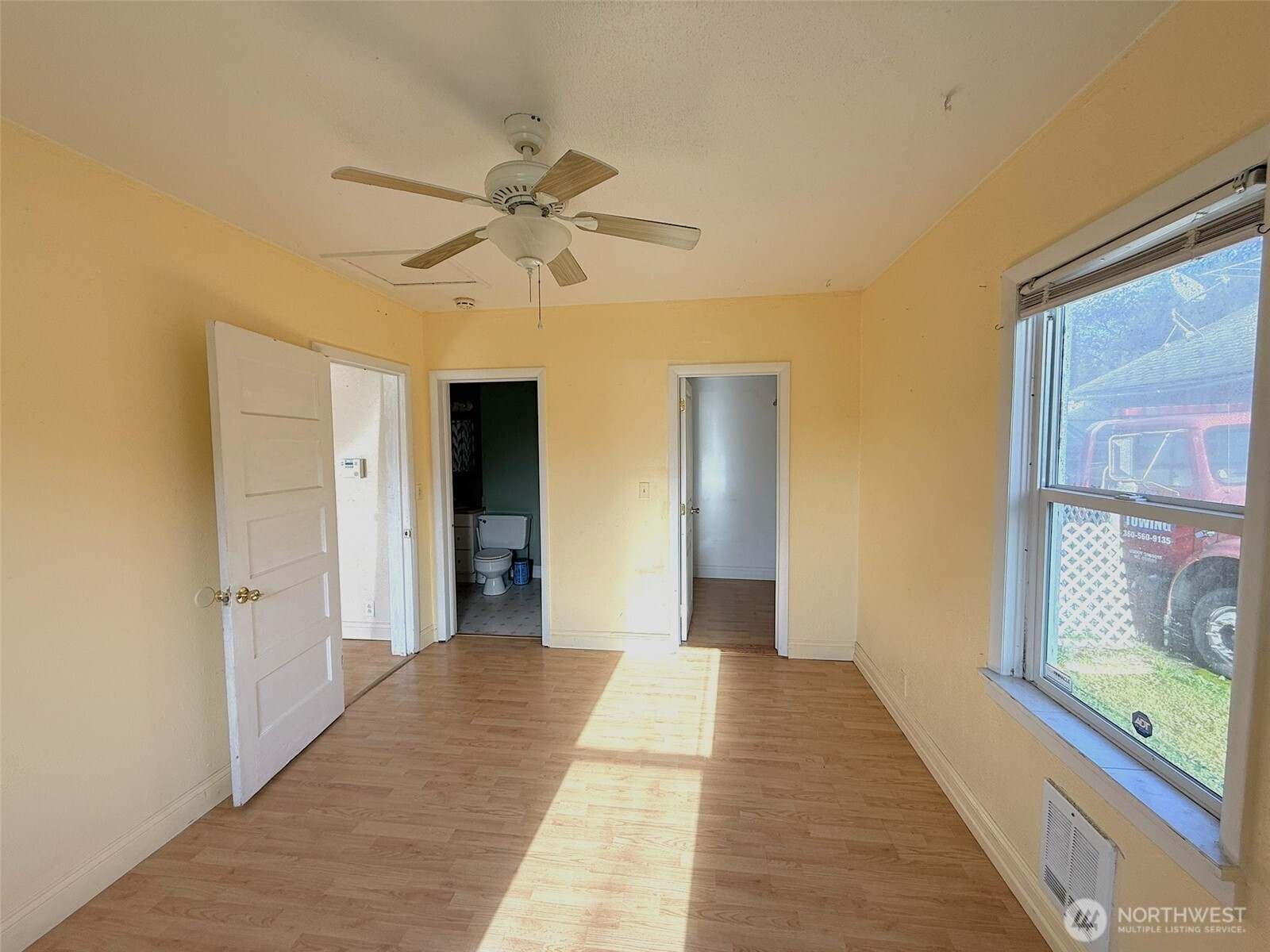 3102 Garfield Street Longview, WA 98632 - Photo 11 of 20 a view of a hallway with a chandelier fan and a window