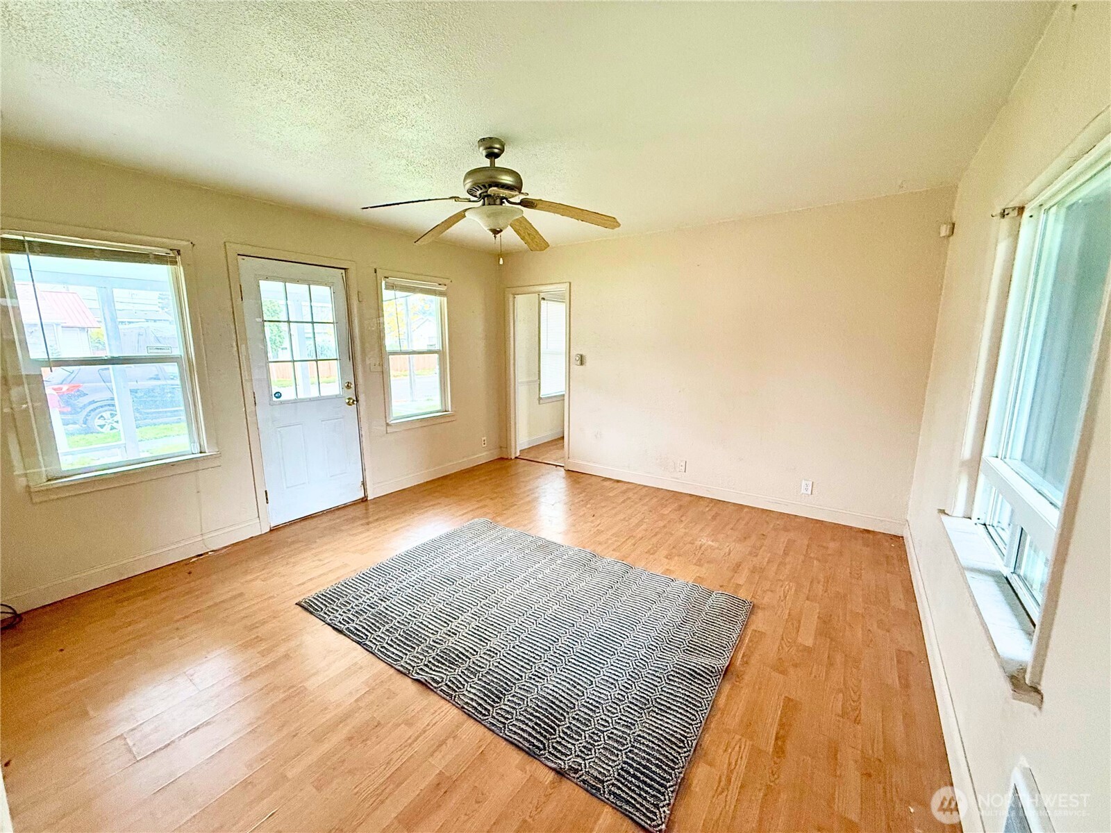 3102 Garfield Street Longview, WA 98632 - Photo 3 of 20 a view of an empty room with window and wooden floor