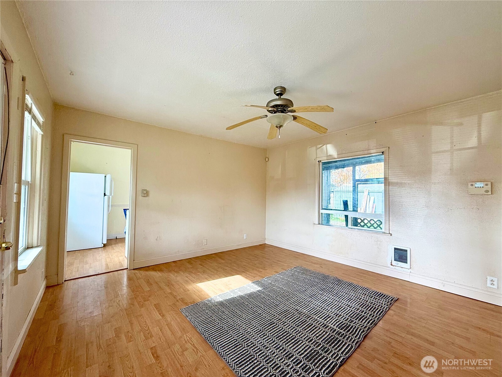3102 Garfield Street Longview, WA 98632 - Photo 4 of 20 wooden floor in an empty room with a window