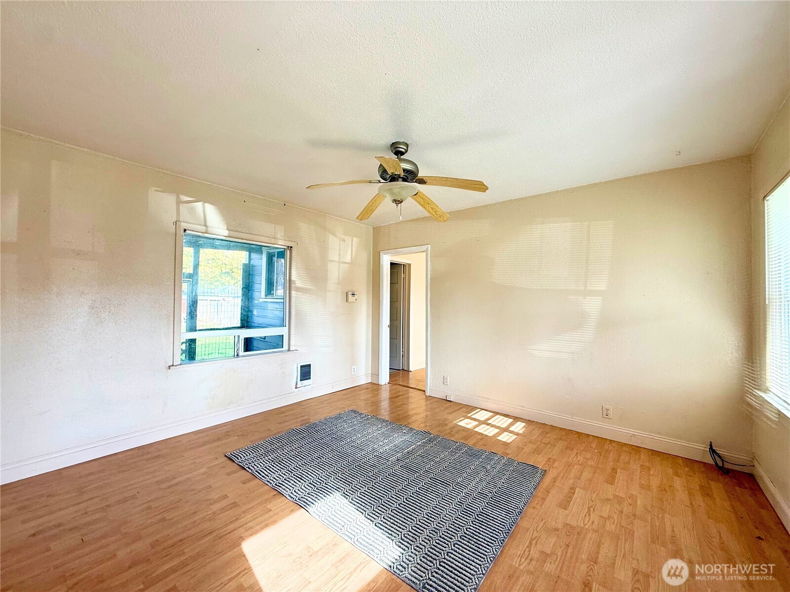 3102 Garfield Street Longview, WA 98632 - Photo 5 of 20 a view of empty room with wooden floor and fan