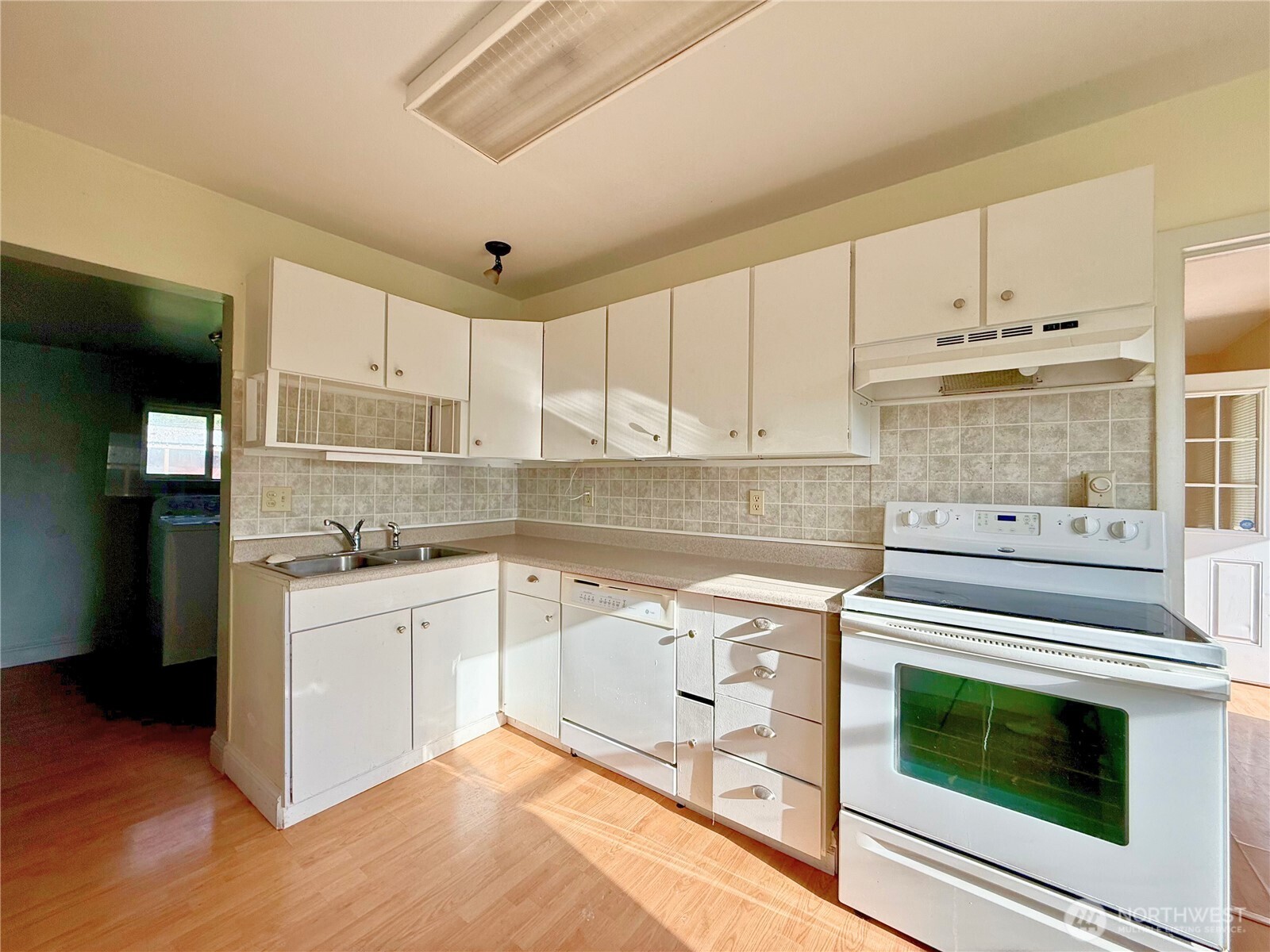 3102 Garfield Street Longview, WA 98632 - Photo 6 of 20 a kitchen with cabinets appliances and wooden floor