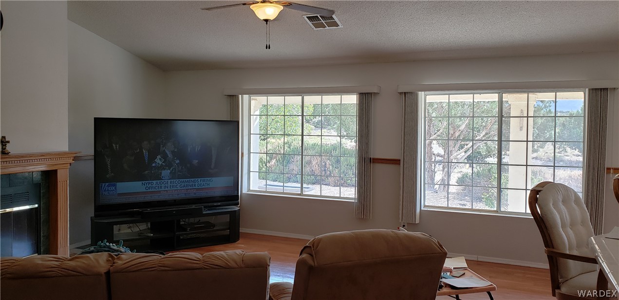 10002 East Blake Ranch Road, Unit 3 Kingman, AZ 86401 - Photo 13 of 42 a living room with furniture a flat screen tv and windows