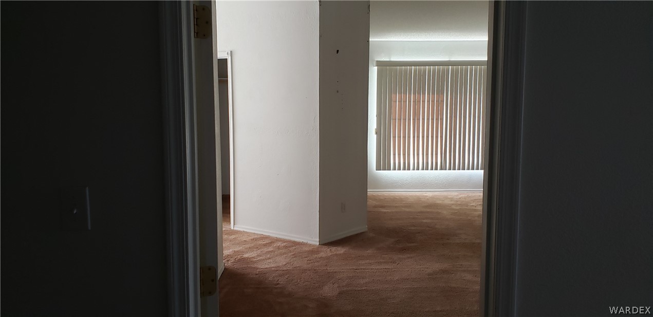 10002 East Blake Ranch Road, Unit 3 Kingman, AZ 86401 - Photo 17 of 42 a view of a livingroom from a hallway