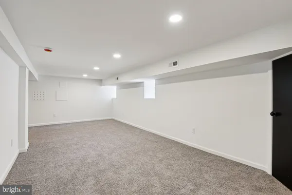 a view of an empty room with windows