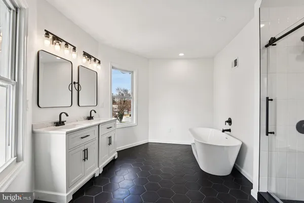 a view of an empty room with closet and wooden floor