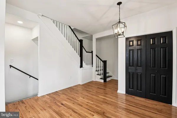 a view of a big room with wooden floor and a ceiling fan