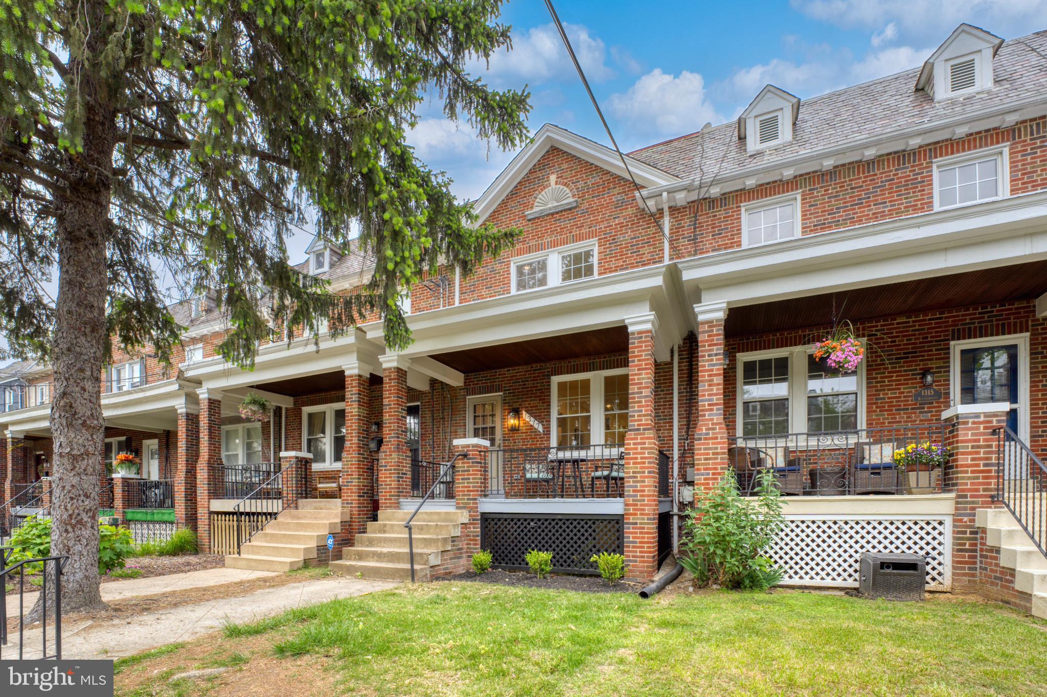 front view of a brick house with a yard