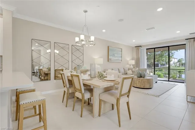 a dining room with furniture a chandelier and window