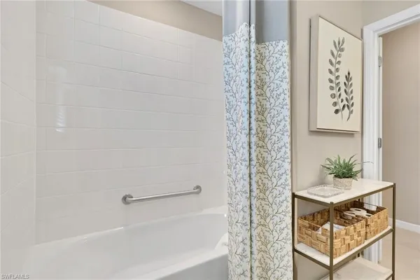 a bathroom with a shower curtain and window