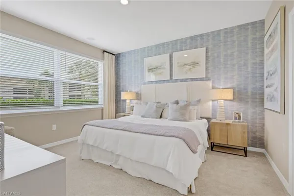 a bedroom with a large bed and a window