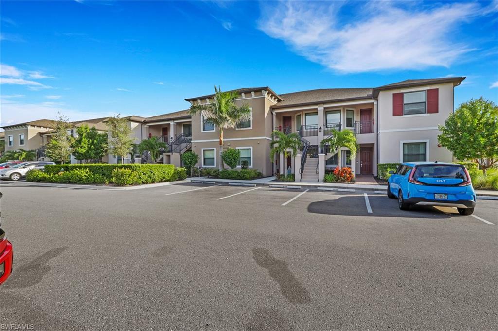 23955 Collina Way, Unit 104 Punta Gorda, FL 33980 - Photo 26 of 45 a front view of a house with a yard