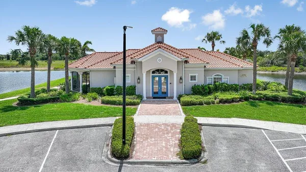 an aerial view of a house with a yard and lake view