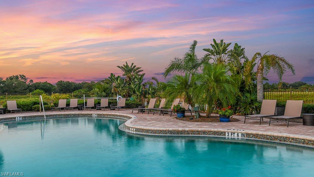 23955 Collina Way, Unit 104 Punta Gorda, FL 33980 - Photo 43 of 45 a view of a lake with a house in the background
