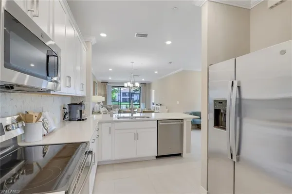 a kitchen with a sink stainless steel appliances and cabinets