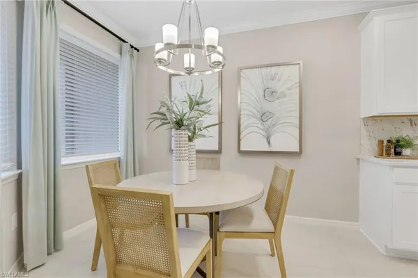 a dining room with furniture and chandelier