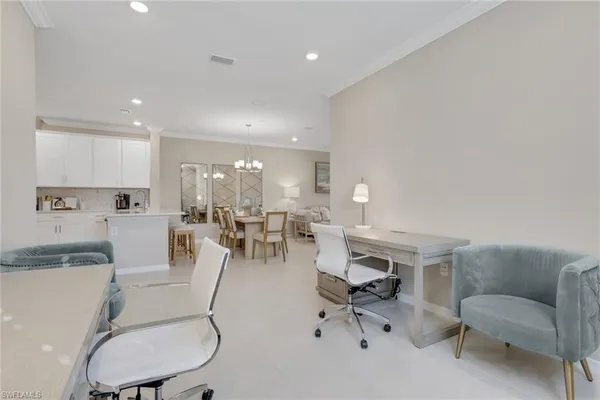 a living room with furniture a white fireplace and white walls
