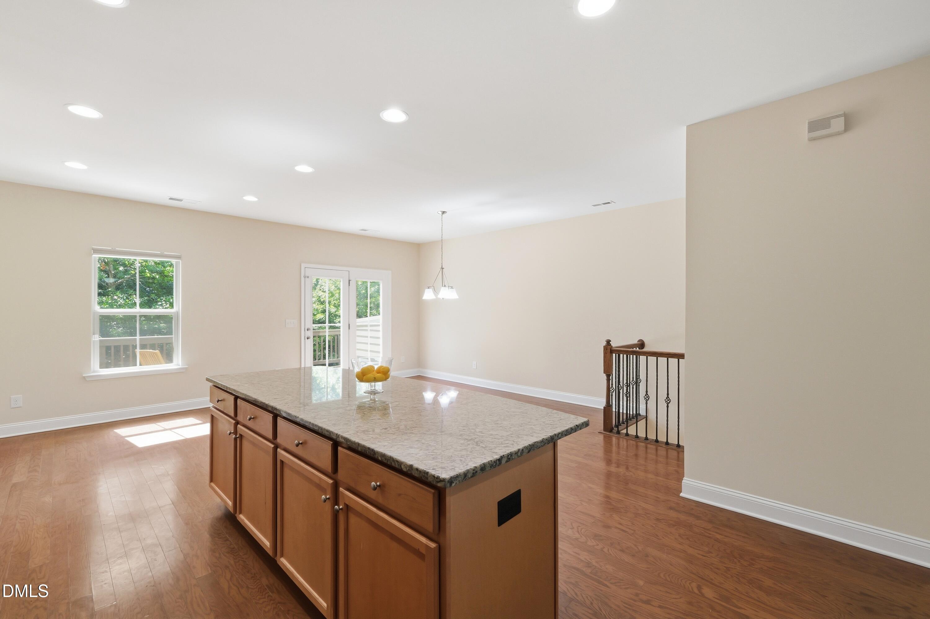 1004 Waymaker Court Apex, NC 27502 - Photo 9 of 30 a kitchen with a stove and wooden floor