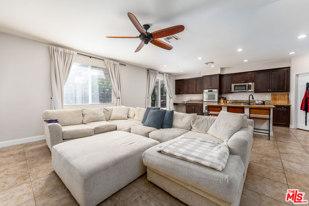 14775 Prairie Smoke Road Eastvale, CA 92880 - Photo 11 of 36 a living room with furniture kitchen view and a window
