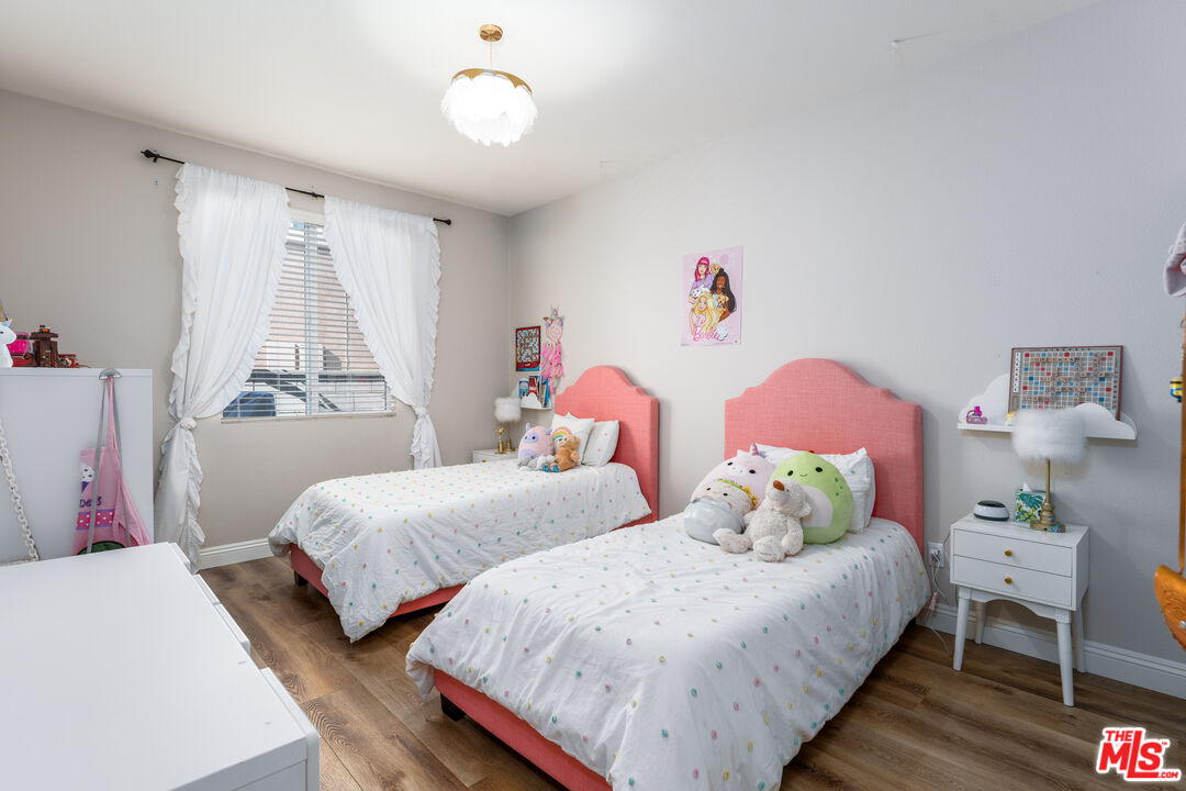 14775 Prairie Smoke Road Eastvale, CA 92880 - Photo 20 of 36 a bedroom with two beds and a window