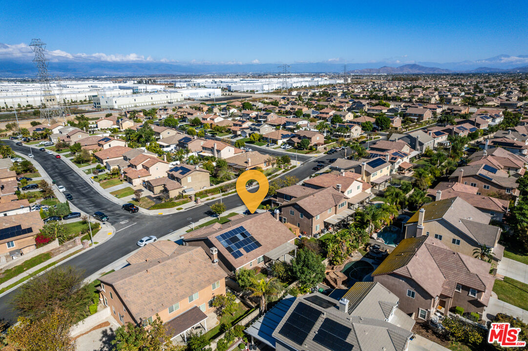 14775 Prairie Smoke Road Eastvale, CA 92880 - Photo 33 of 36 an aerial view of a city with lots of residential buildings and ocean view in back