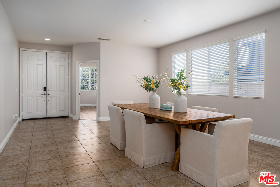 14775 Prairie Smoke Road Eastvale, CA 92880 - Photo 5 of 36 a view of kitchen island with stainless steel appliances granite countertop a sink and a counter top space