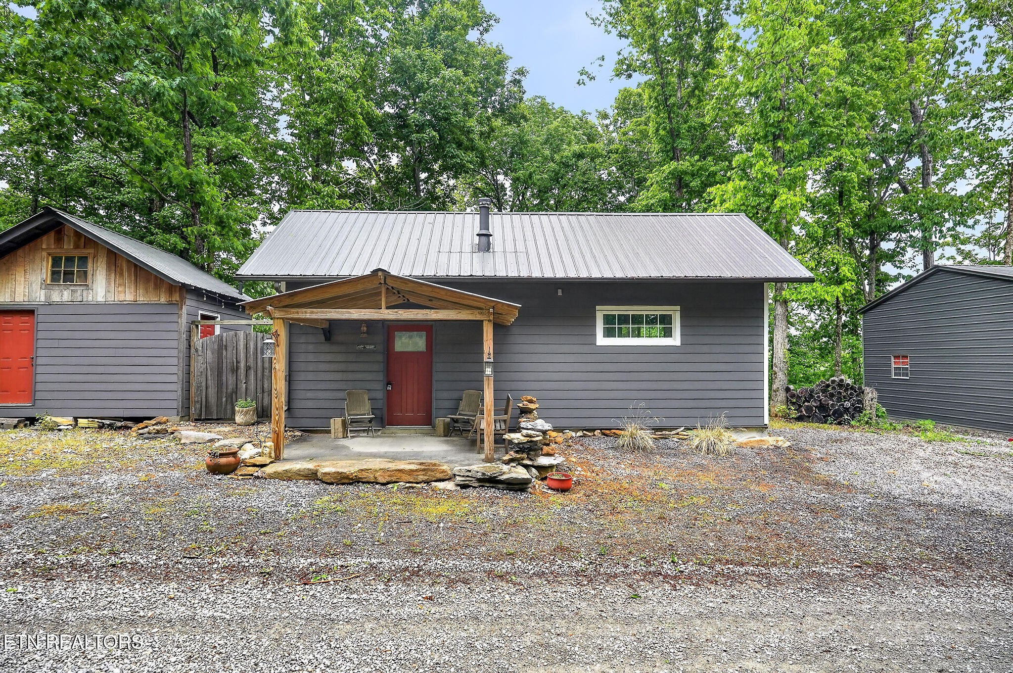 853 Rock Springs Road Celina, TN 38551 - Photo 1 of 21 a backyard of a house with yard and garage