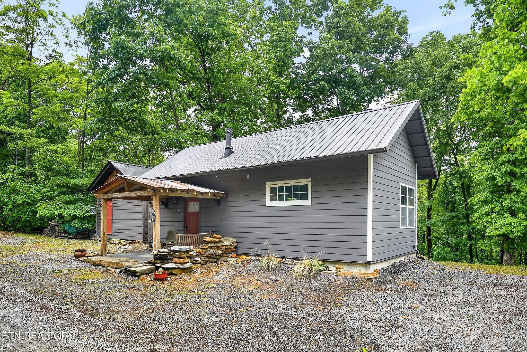 853 Rock Springs Road Celina, TN 38551 - Photo 2 of 21 a backyard of a house with table and chairs under an umbrella