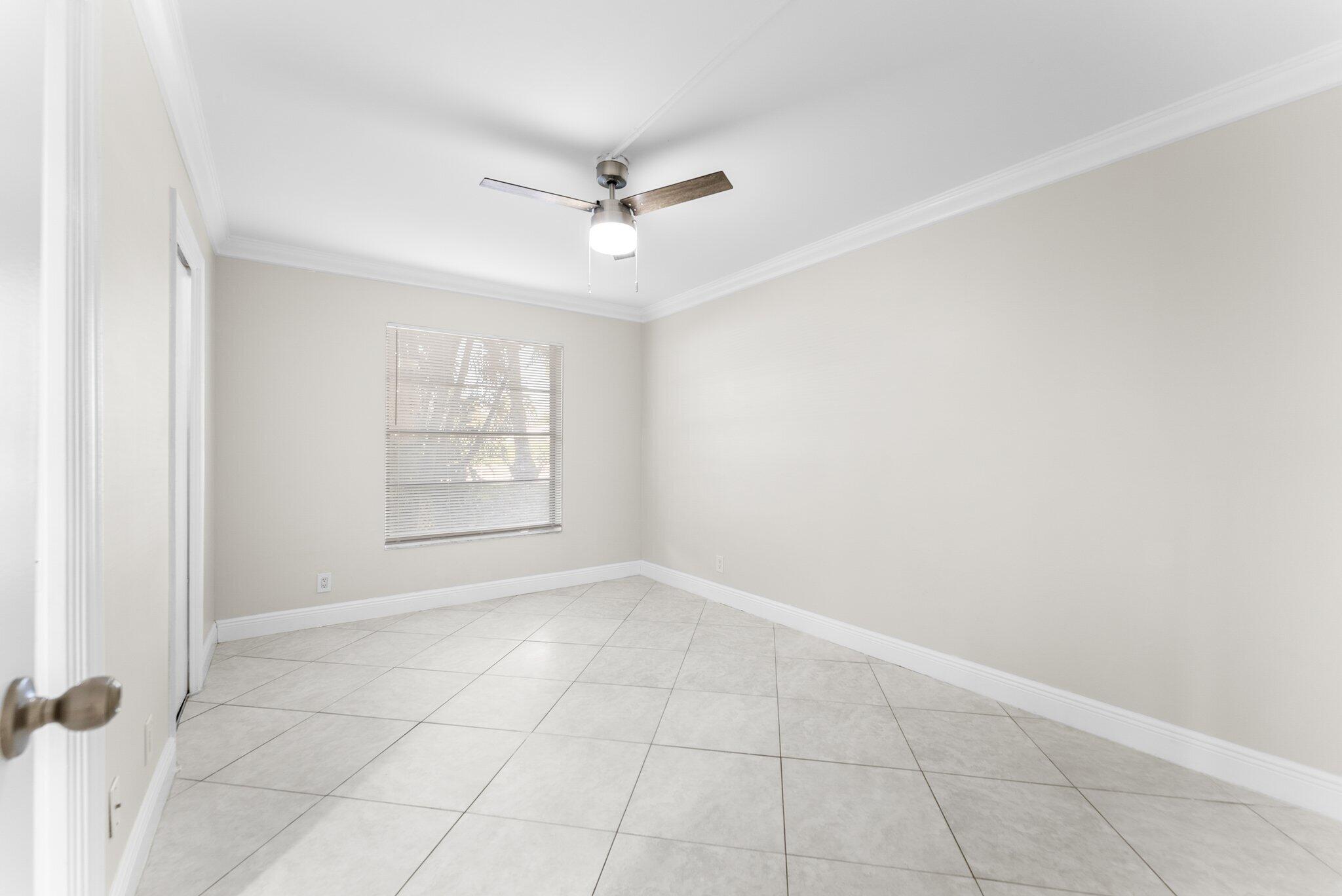 23490 Lyons Road, Unit 605 Boca Raton, FL 33428 - Photo 16 of 39 an empty room with windows and fan