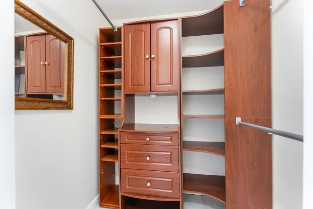 a view of walk in closet with empty racks