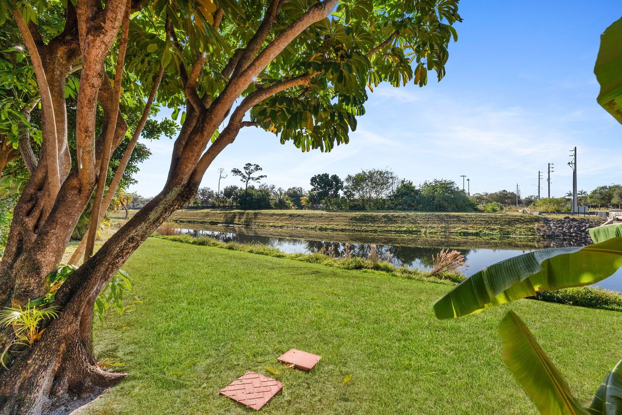 23490 Lyons Road, Unit 605 Boca Raton, FL 33428 - Photo 25 of 39 a view of a lake with a yard