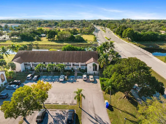 an aerial view of a house with yard swimming pool and outdoor seating