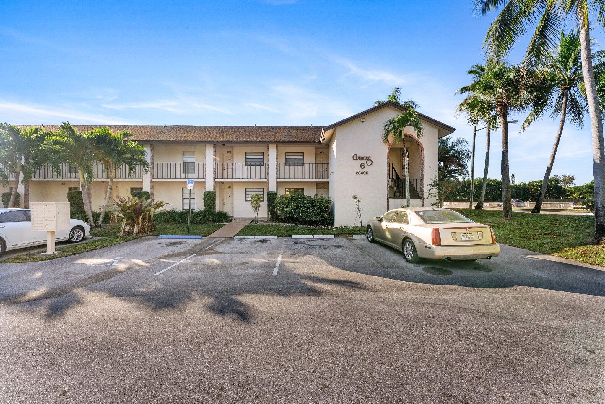 23490 Lyons Road, Unit 605 Boca Raton, FL 33428 - Photo 3 of 39 a view of a white house with a sink and yard