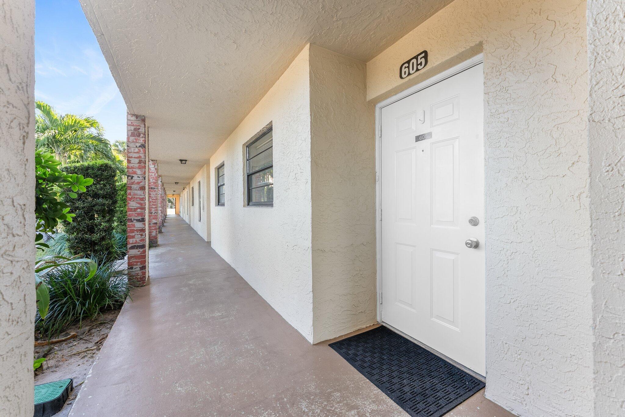 23490 Lyons Road, Unit 605 Boca Raton, FL 33428 - Photo 4 of 39 a view of a hallway with wooden floor and entryway