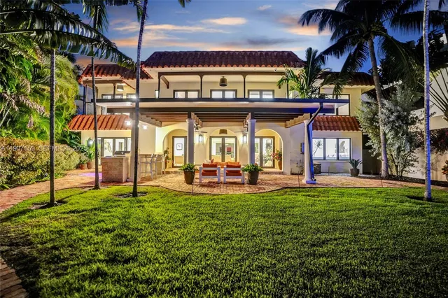 a view of a house with a yard patio and fire pit