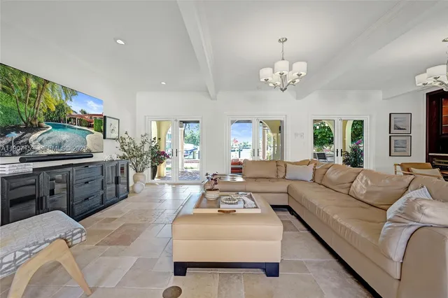 a view of a dining room with furniture and chandelier