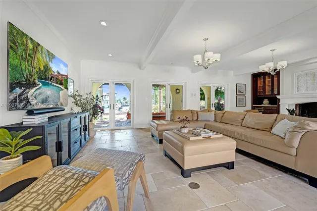 a kitchen with a dining table chairs and white cabinets