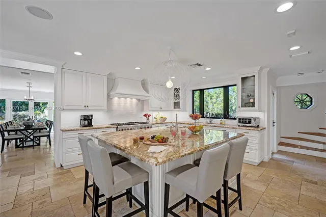 a living room with furniture a flat screen tv and a large window