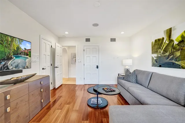 a living room with patio furniture and a large window